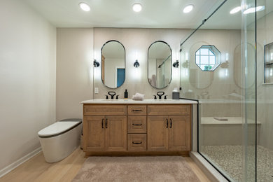Mid-sized master porcelain tile double-sink bathroom photo in Cleveland with flat-panel cabinets, light wood cabinets, a bidet, an undermount sink, quartz countertops, white countertops and a built-in vanity
