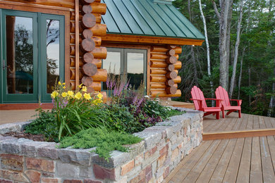 Deck - large rustic backyard deck idea in Other with no cover