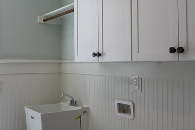 Country laundry room in Raleigh with shaker cabinets, white cabinets, ceramic floors, a side-by-side washer and dryer and grey floor.