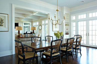 Transitional dark wood floor kitchen/dining room combo photo in New York with blue walls