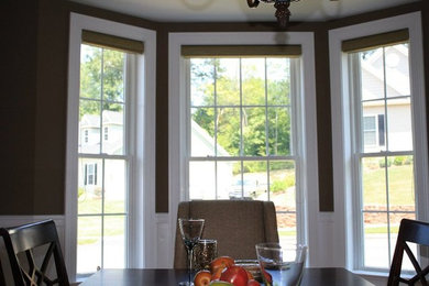 Elegant dining room photo in New York with brown walls