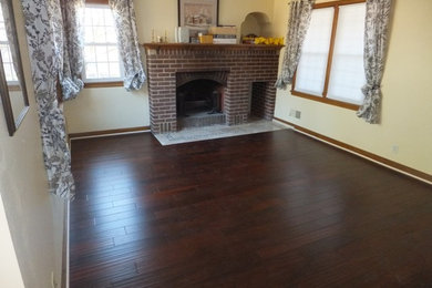 Inspiration for a mid-sized traditional formal enclosed living room in Minneapolis with beige walls, dark hardwood floors, a standard fireplace, a brick fireplace surround, no tv and brown floor.