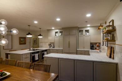 Mid-sized trendy eat-in kitchen photo in Other with marble countertops and paneled appliances