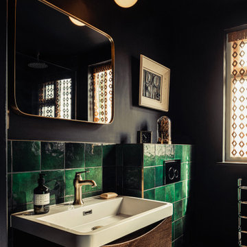 Dark bathroom with green tiles