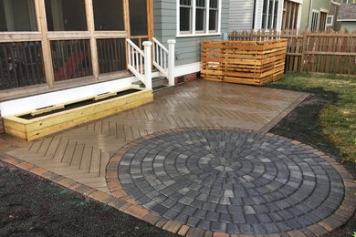 This is an example of a mid-sized transitional backyard patio in Charlotte with a container garden, concrete pavers and no cover.