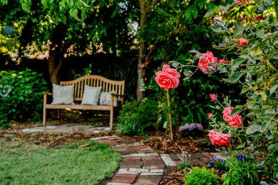 Design ideas for a mid-sized traditional partial sun backyard brick and wood fence garden path in San Francisco.