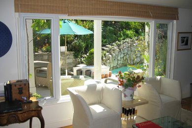 Traditional living room in Los Angeles with medium hardwood floors and brown floor.