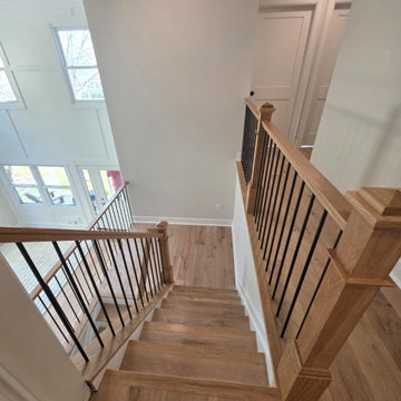 Metal and Wood Indoor Railing Installation with Red Oak T-Rail & Black Balusters