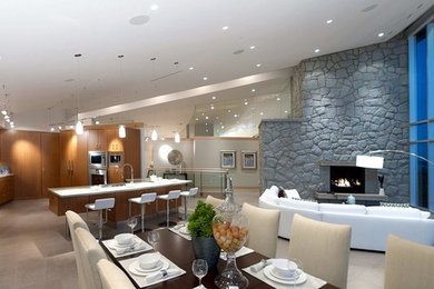 Huge trendy u-shaped ceramic tile open concept kitchen photo in Vancouver with an undermount sink, flat-panel cabinets, medium tone wood cabinets, granite countertops, gray backsplash, glass sheet backsplash, paneled appliances and a peninsula