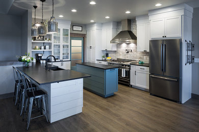Example of a mid-sized cottage kitchen design in Other with a farmhouse sink, shaker cabinets, white cabinets, granite countertops, white backsplash, subway tile backsplash, black appliances and two islands