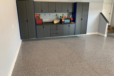 Garage workshop - large modern detached three-car garage workshop idea in Detroit