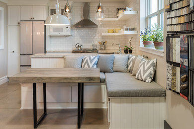 Small transitional u-shaped eat-in kitchen photo in Grand Rapids with an undermount sink, shaker cabinets, white cabinets, laminate countertops, white backsplash, subway tile backsplash, stainless steel appliances and a peninsula