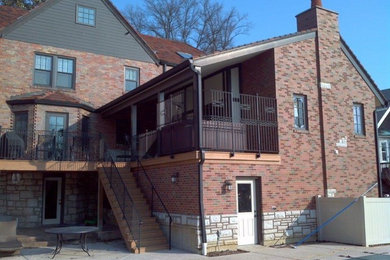 Example of a large classic brown two-story brick exterior home design in St Louis