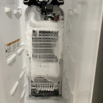 Freezer repair in Miami — evaporator coil iced over behind the rear panel