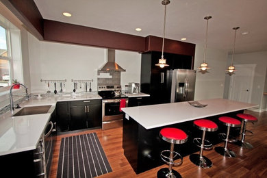 Example of a mid-sized trendy l-shaped eat-in kitchen design in Other with a farmhouse sink, flat-panel cabinets, black cabinets and an island