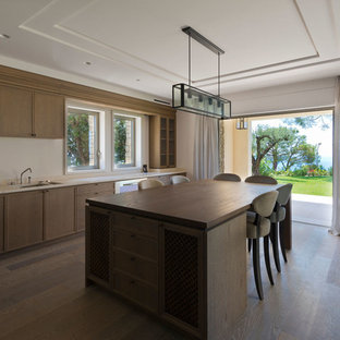 Large mediterranean kitchen pantry appliance - Example of a large tuscan l-shaped medium tone wood floor kitchen pantry design in Nice with an island, flat-panel cabinets, medium tone wood cabinets, marble countertops, stone slab backsplash, stainless steel appliances and a double-bowl sink