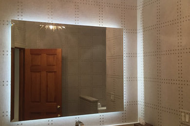 Example of a mid-sized trendy 3/4 bathroom design in New York with a two-piece toilet, multicolored walls, an undermount sink and marble countertops