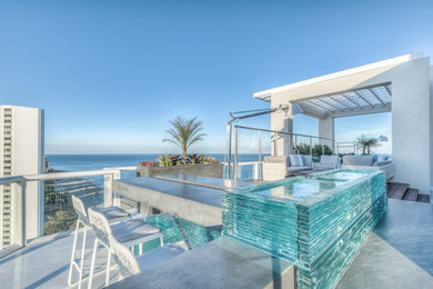 Inspiration for a huge modern rooftop deck remodel in Miami with a fire pit and no cover