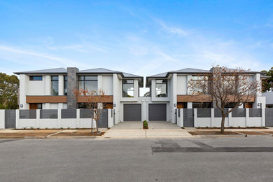 Photo of a contemporary two-storey grey townhouse exterior in Adelaide.