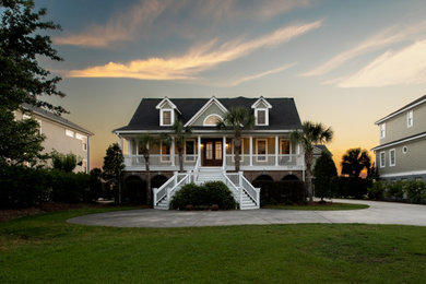 Large transitional green two-story exterior home photo in Charleston with a black roof