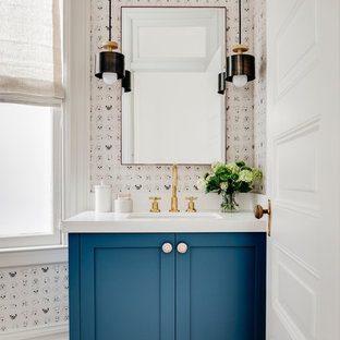 Powder room - transitional medium tone wood floor and brown floor powder room idea in San Francisco with shaker cabinets, blue cabinets, white walls, an undermount sink and white countertops
