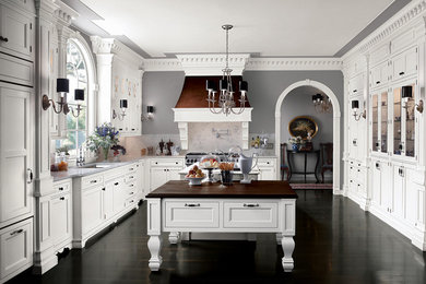 Inspiration for a large timeless u-shaped dark wood floor kitchen remodel in Phoenix with shaker cabinets, white cabinets, wood countertops, gray backsplash, stone slab backsplash and stainless steel appliances