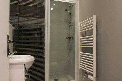 This is an example of a small modern 3/4 bathroom in Paris with gray tile.