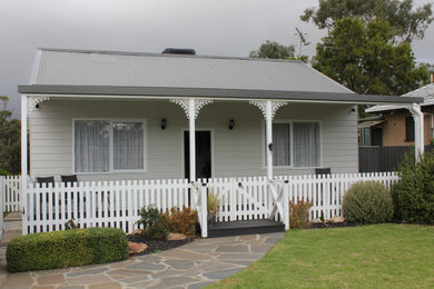 Photo of a traditional front yard verandah in Adelaide with wood railing.