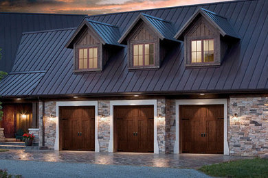 Garage - mid-sized traditional attached three-car garage idea in Calgary