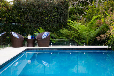 This is an example of a mid-sized contemporary backyard rectangular lap pool in Sydney with brick pavers.