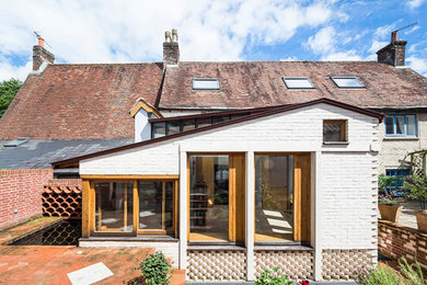 Inspiration for a small and white country bungalow brick terraced house in Dorset with a pitched roof and a metal roof.