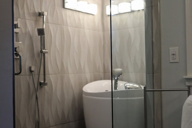Large trendy master gray tile and porcelain tile porcelain tile and gray floor bathroom photo in Cincinnati with shaker cabinets, blue cabinets, gray walls, an integrated sink, quartz countertops, a hinged shower door and white countertops