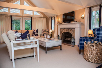 Family room - large transitional enclosed carpeted and beige floor family room idea in Boston with beige walls, a standard fireplace, a stone fireplace and a wall-mounted tv