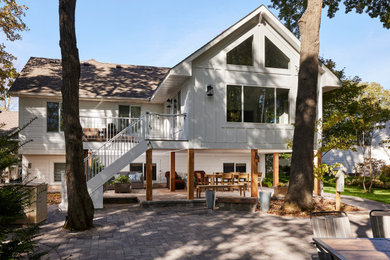 Example of a huge white one-story wood and board and batten exterior home design in Minneapolis with a shingle roof and a black roof