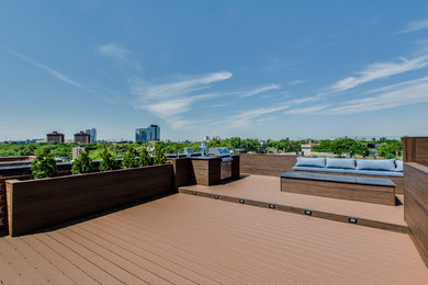 This is an example of a large modern rooftop deck in Chicago with a fire feature and no cover.