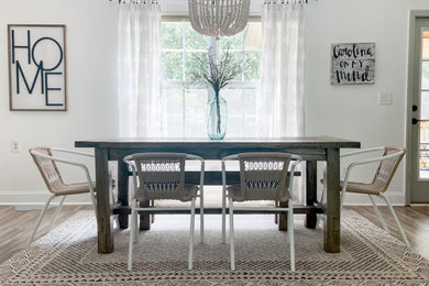 Inspiration for a mid-sized transitional laminate floor and gray floor great room remodel in Raleigh with white walls