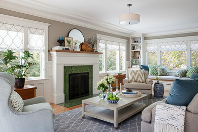This is an example of a traditional living room in San Francisco with grey walls, medium hardwood floors, a tile fireplace surround and brown floor.