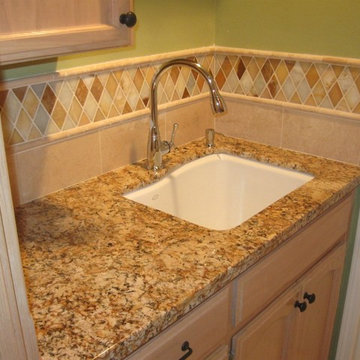 Juparana Granite counter-top with a rhomboid onyx back-splash