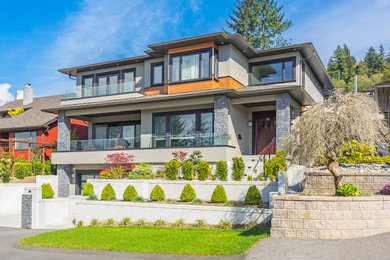 Large contemporary beige three-story stucco exterior home idea in Other with a shingle roof