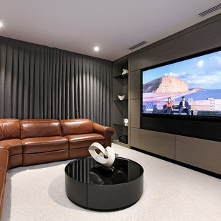This is an example of a contemporary home cinema in Auckland with grey walls, carpet and white floors.