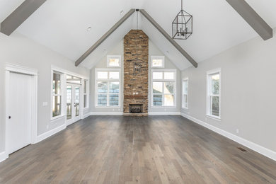 Inspiration for a mid-sized modern open concept porcelain tile and gray floor living room remodel in Other with gray walls, a standard fireplace and a stone fireplace