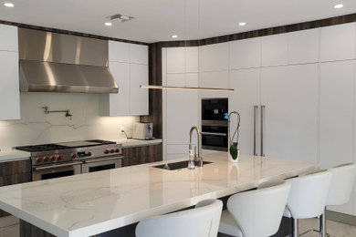 Inspiration for a modern kitchen pantry remodel in Miami with an island and white countertops