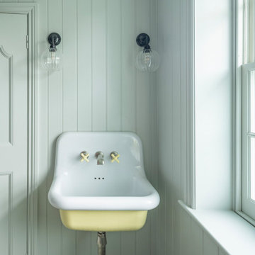 Ensuite bathroom with panelled walls and wall mounted sink