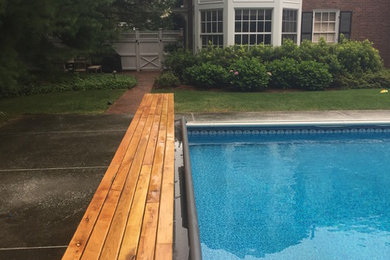 Elegant backyard rectangular pool photo in Boston