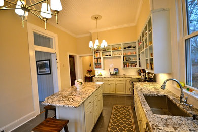 Example of a mid-sized trendy u-shaped eat-in kitchen design in Other with raised-panel cabinets, white cabinets, granite countertops, stainless steel appliances and an island
