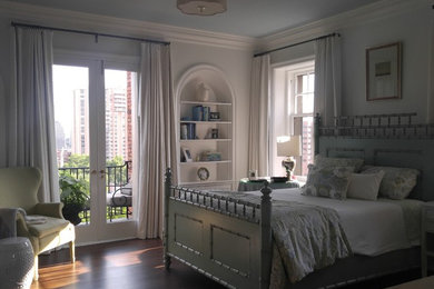 Inspiration for a mid-sized timeless guest medium tone wood floor and brown floor bedroom remodel in Kansas City with white walls and no fireplace