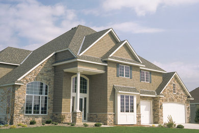 Large elegant brown two-story mixed siding exterior home photo in Minneapolis with a hip roof