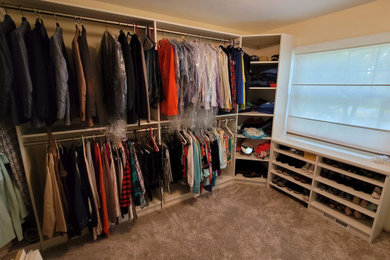 Example of a large minimalist gender-neutral carpeted and beige floor walk-in closet design in Other with open cabinets and white cabinets