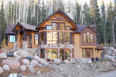 Example of a huge mountain style brown two-story mixed siding exterior home design in Albuquerque with a shingle roof