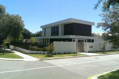 Inspiration for a large contemporary two-storey white exterior in Perth with concrete fiberboard siding and a flat roof.